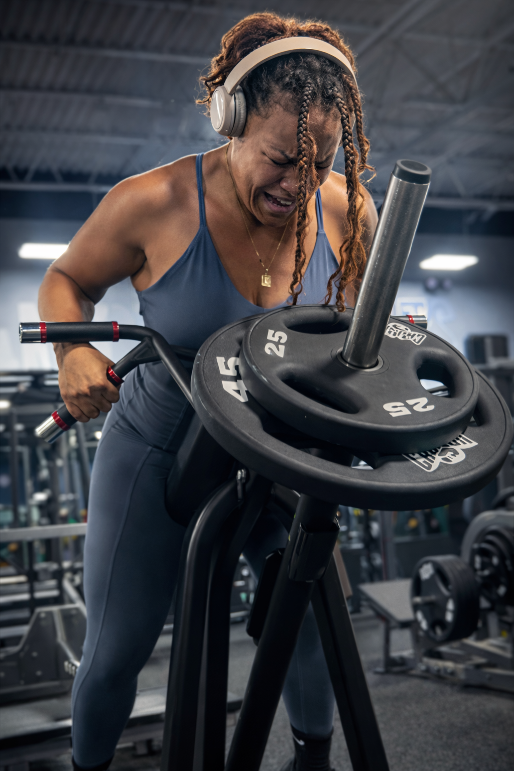 Woman training hard on an assault bike in the gym
